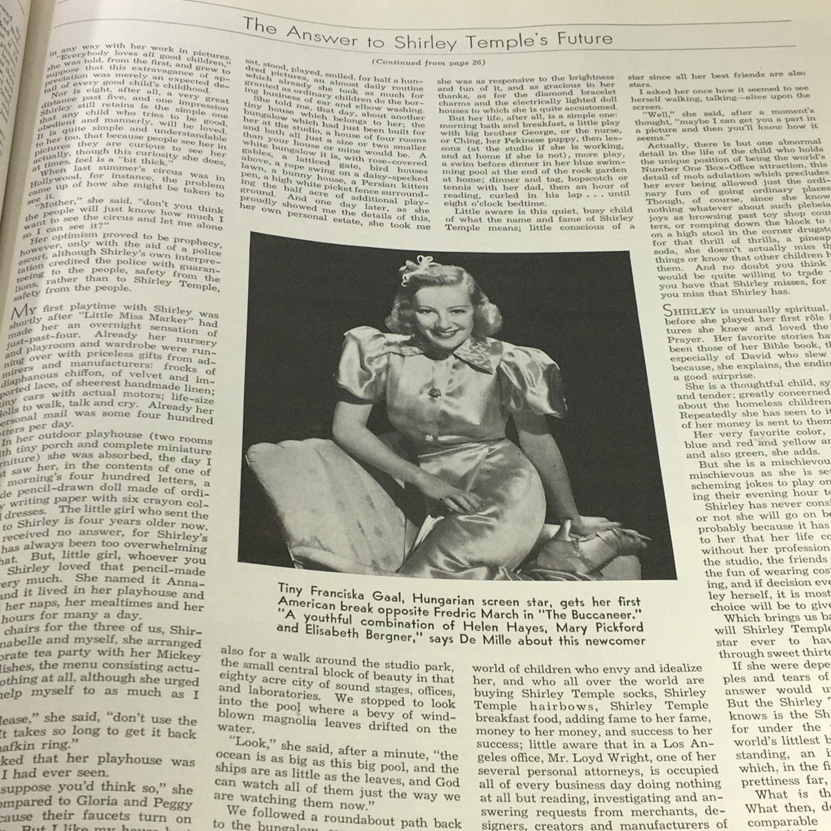 An article in the VTG Photoplay Magazine November 1937 discussing the future of star Shirley Temple alongside personal anecdotes and insights, complemented by a portrait photograph of Temple in a stylish outfit.