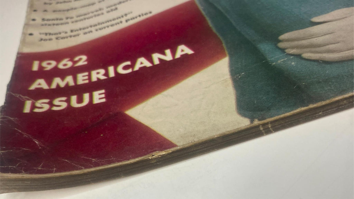 Close-up of the spine of Vogue Magazine February 1, 1962 highlighting the Americana issue with visible wear and historical character.