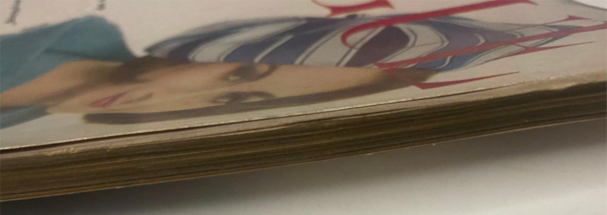 Detailed view of the side of Vogue Magazine February 1, 1962, illustrating the age and vintage quality of the publication.
