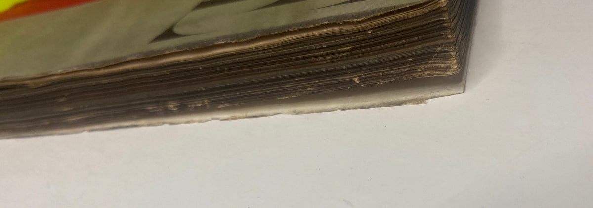 Side view of the pages of Vogue Magazine March 15, 1947 exhibiting age-related wear, including browning edges typical of old magazines.