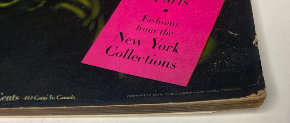 Close-up of the cover edge of Vogue Magazine October 15, 1944 Meg Mundy Cover by John Rawlings, showing vintage tag for New York fashion collections.