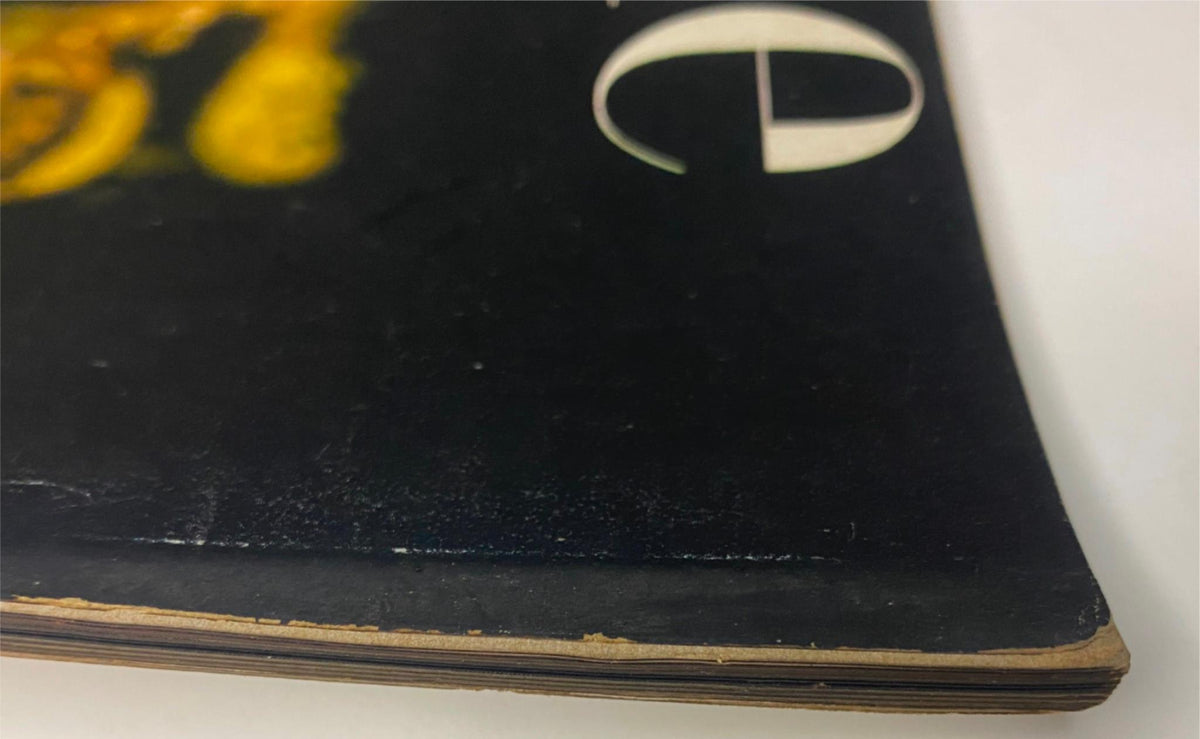 Detailed view of the corner of Vogue Magazine October 15, 1944 Meg Mundy Cover by John Rawlings, displaying a vintage publication's spine with wear.