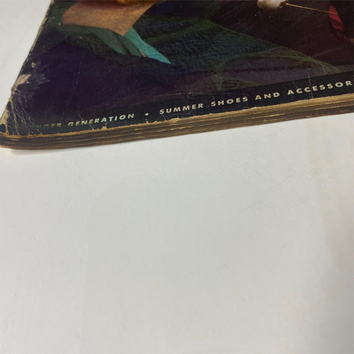 Vogue Magazine May 1, 1938 corner of the cover showcasing wear and tear typical of vintage magazines.