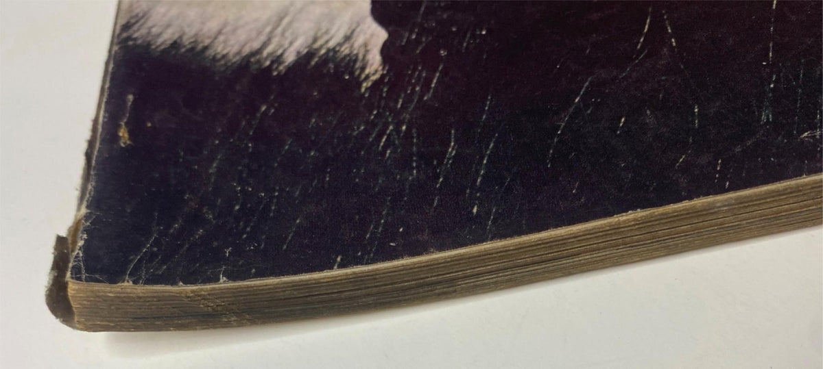 Damage detail of a vintage Vogue Magazine September 15, 1962, titled 'The Blaze in Fashion', highlighting wear on the spine and corner of the publication.