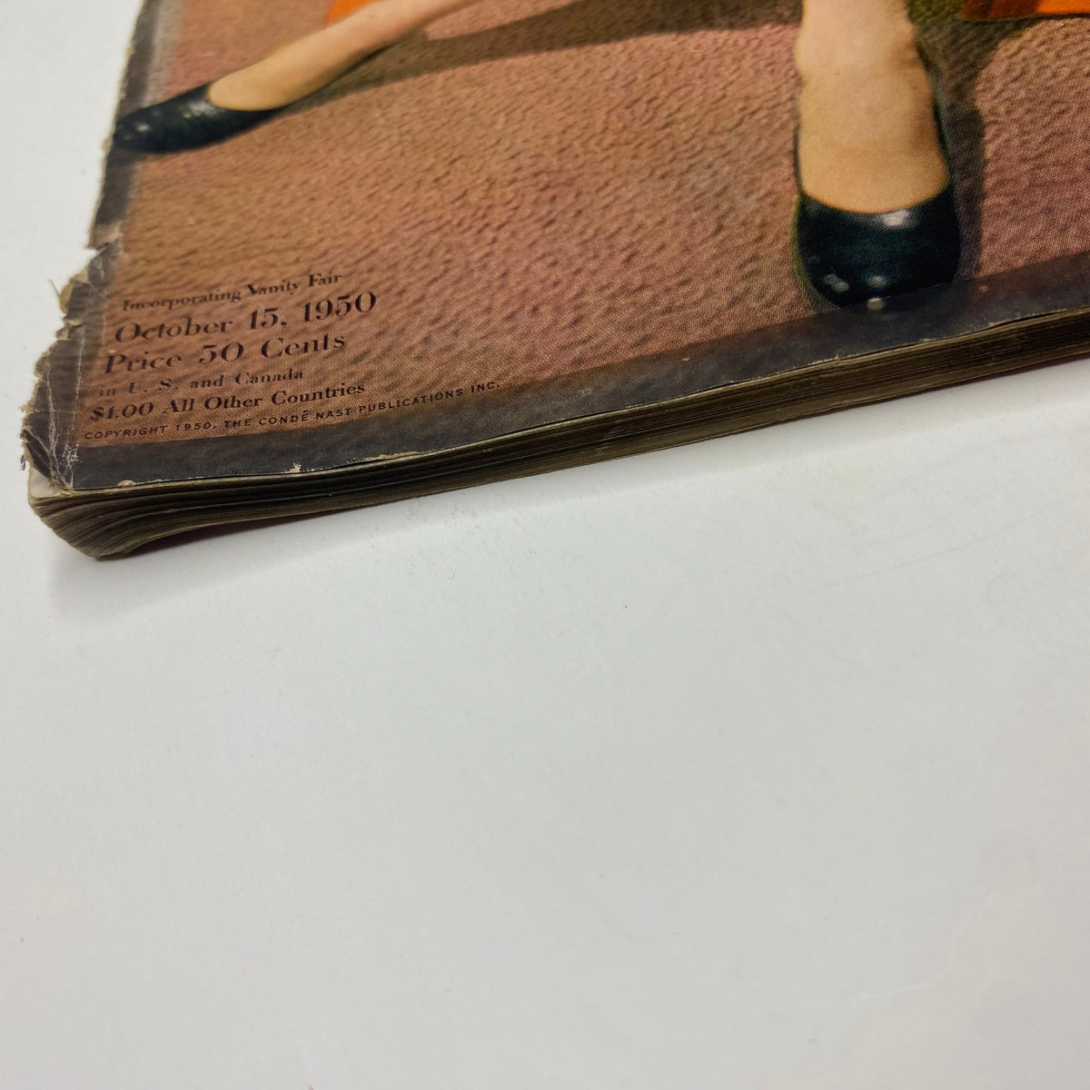 Close-up image of the cover edge of Vogue Magazine October 15, 1950, displaying wear consistent with vintage publications. The magazine features model Jean Patchett captured by Horst P. Horst.