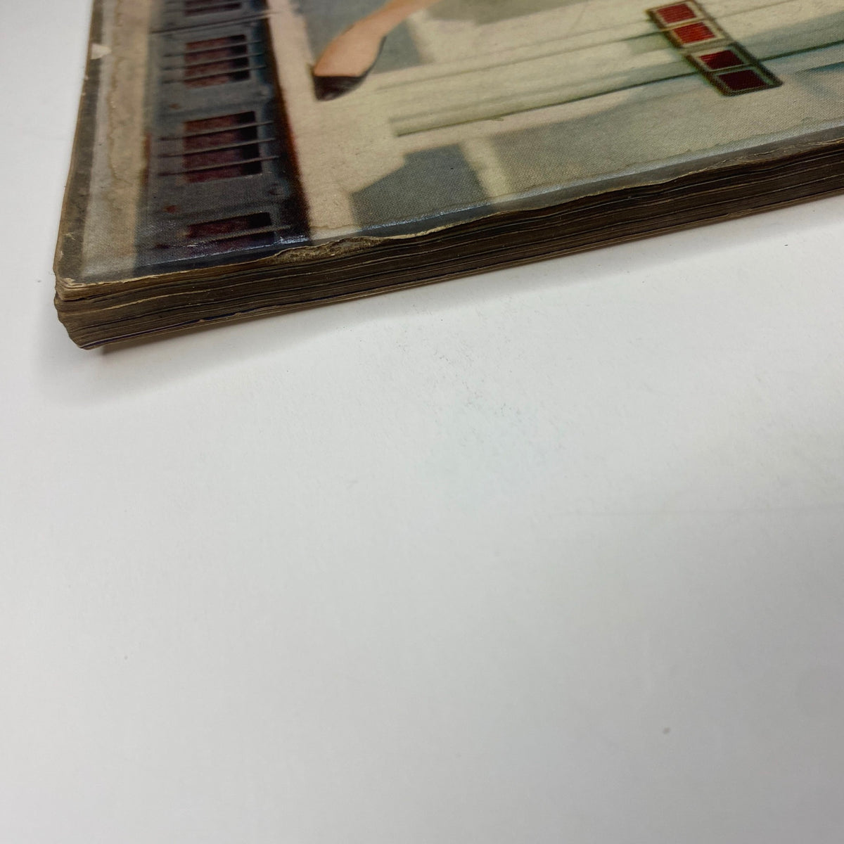 Close-up view of the spine of Vogue Magazine, October 1, 1957, featuring Mary McLaughlin on the cover, photograph by William Klein. Shows vintage wear and uniqueness of this collectible magazine.