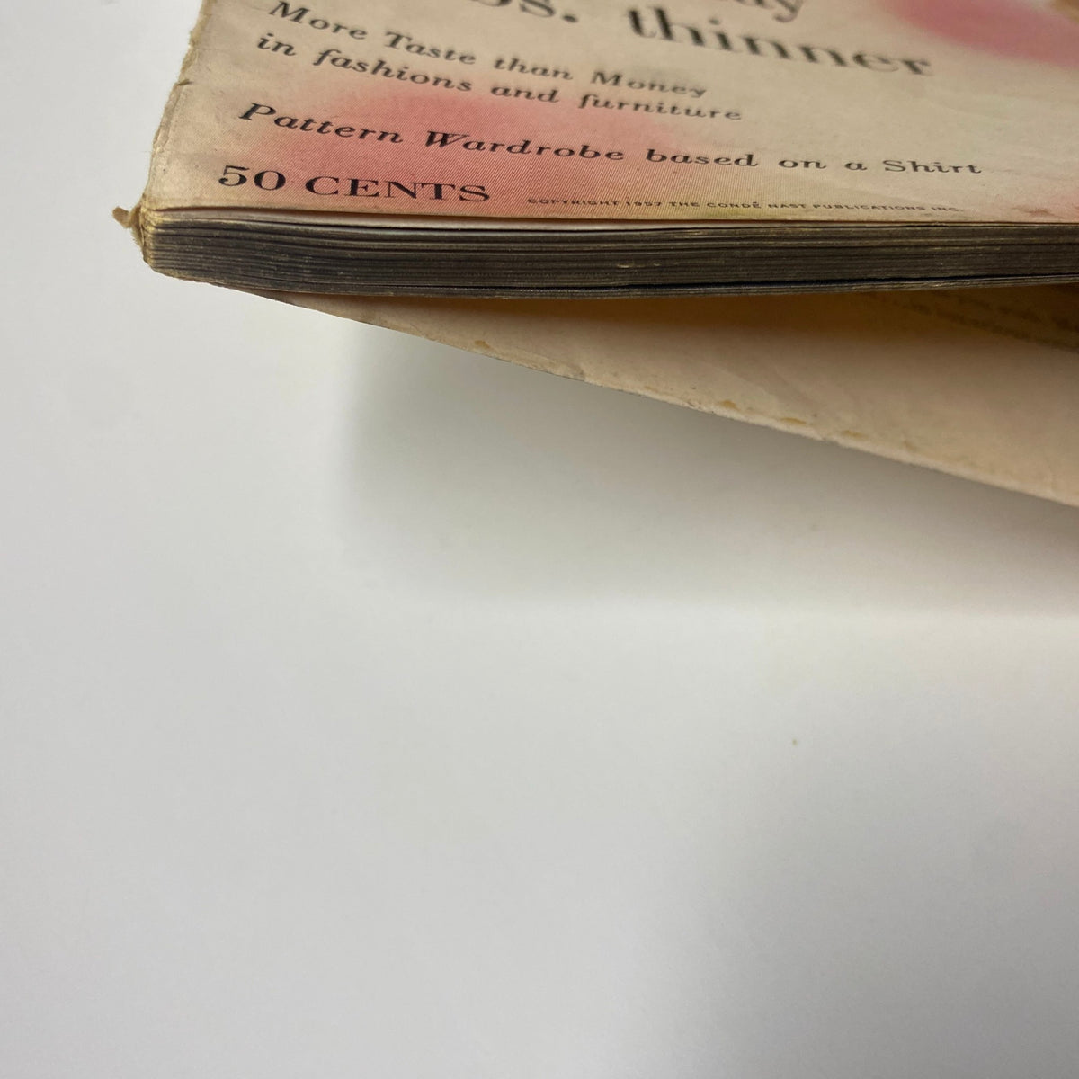 Vogue Magazine February 15, 1957 featuring Anne St. Marie by Karen Radkai, focusing on the magazine's spine showing signs of wear typical in vintage publications.