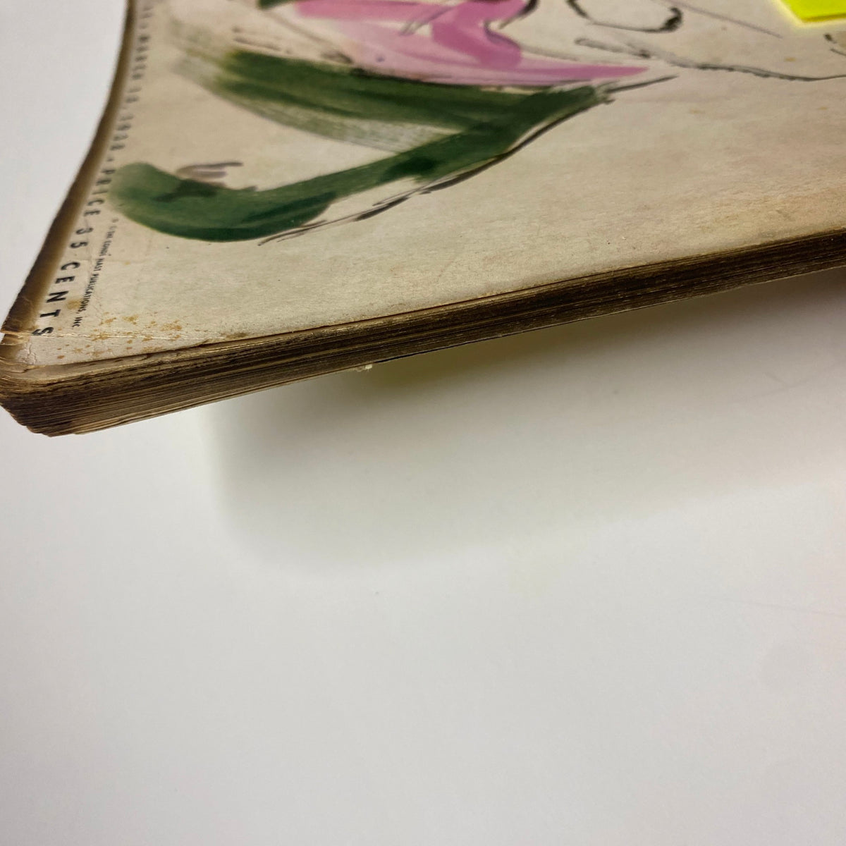 Close-up of the edge of Vogue Magazine March 15, 1938, displaying age-related wear, important for collectors focusing on vintage magazine preservation.