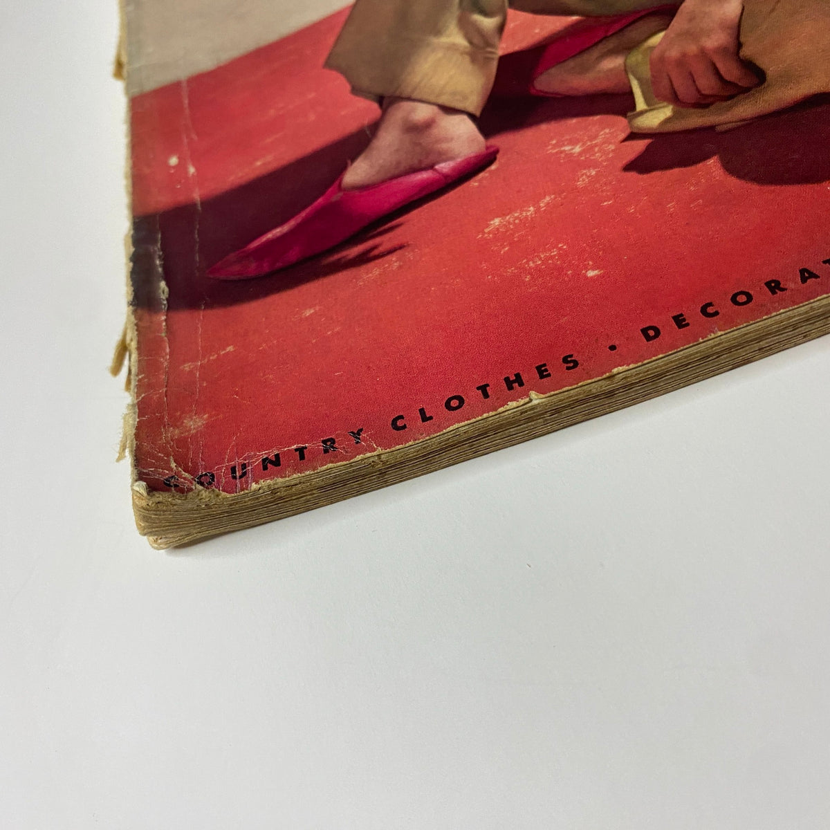 Close-up of the spine of Vogue Magazine April 15, 1939, highlighting wear and tear along the edges with visible vintage design elements.