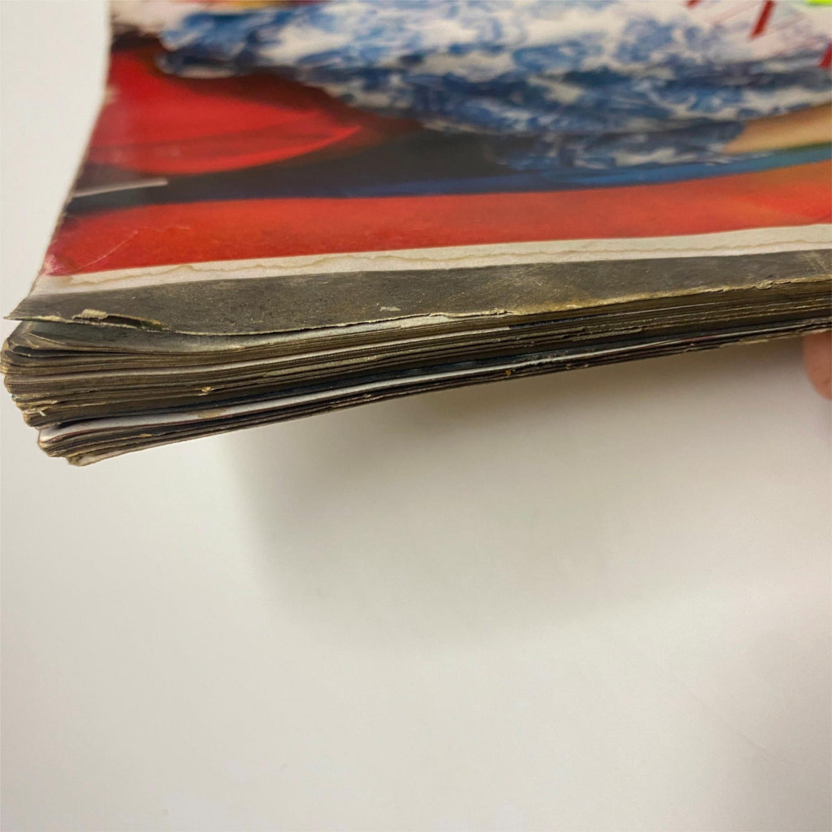 Side view of the vintage Vogue Magazine February 1, 1957 with Joanna McCormick cover by Irving Penn showing mild wear and aging along the spine and pages.