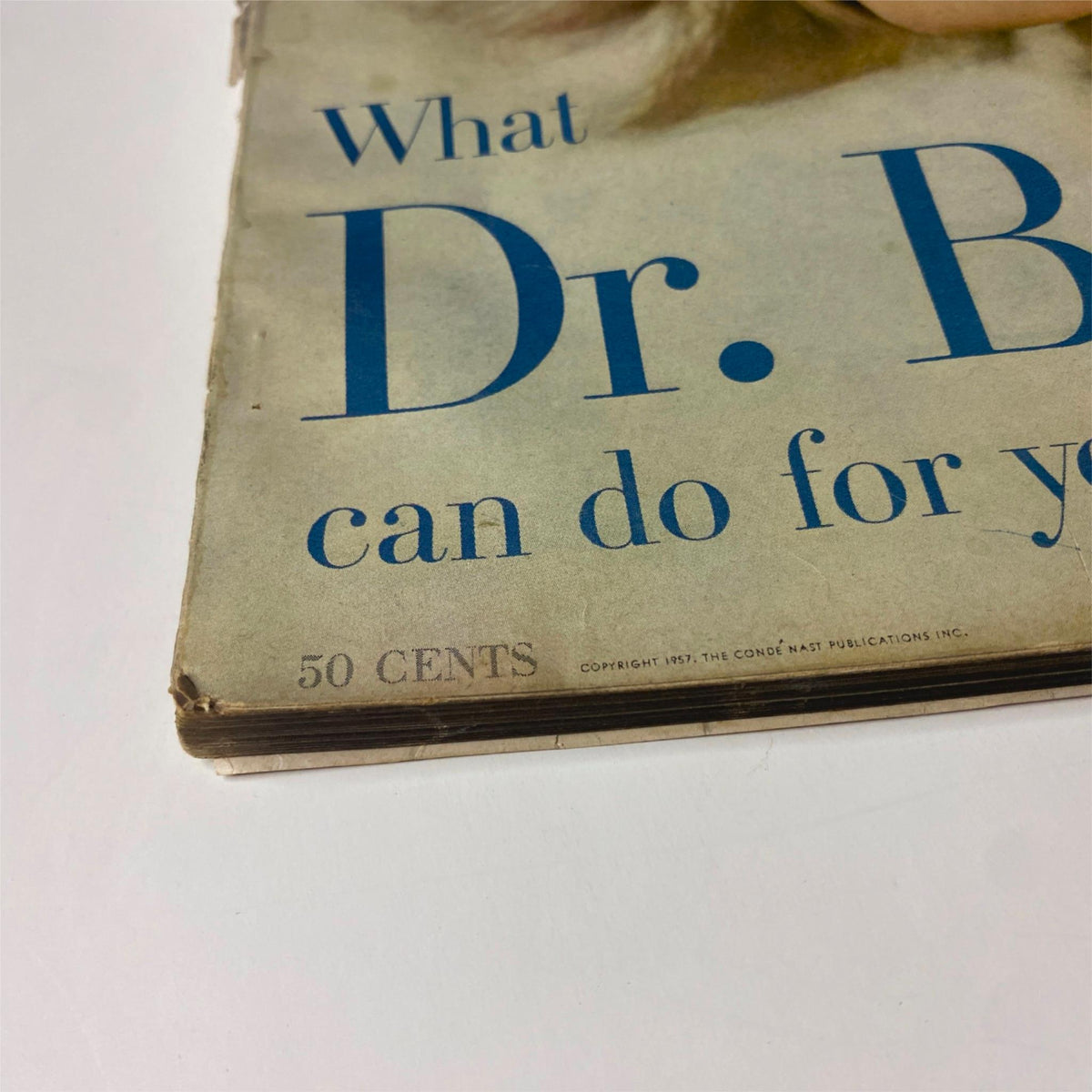 Close-up view of the spine of Vogue Magazine May 1957, highlighting the price and details of the beauty section, including 'What Dr. Beauty can do for you.' Ann Klem Cover by Irving Penn.