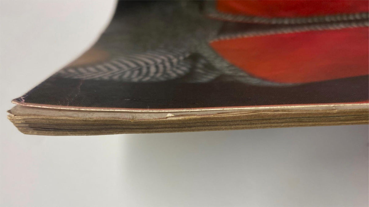Close-up view of the edge of Vogue Magazine August 15, 1961, showing minor damage and genuine vintage characteristics, emphasizing the magazine's history and collectible nature.