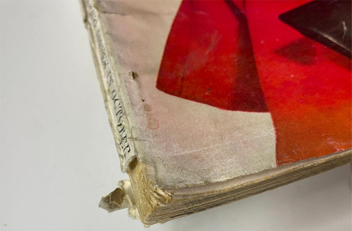 Close-up image of the October 1, 1960 Vogue Magazine, highlighting the wear on the binding with visible age marks and delicate pages, illustrating the magazine's vintage character.
