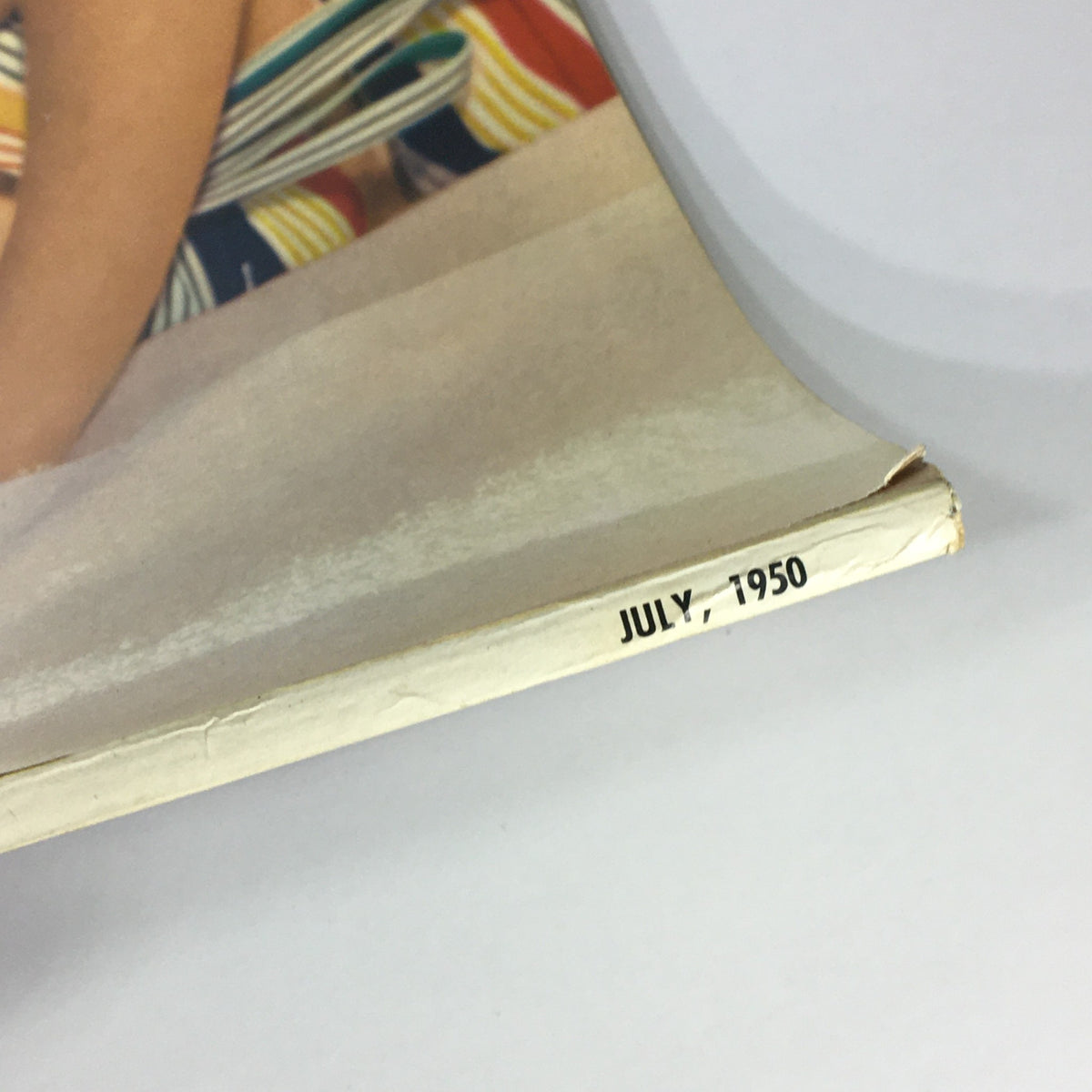 Bottom edge of VTG Popular Photography Magazine July 1950 displaying the date July 1950.