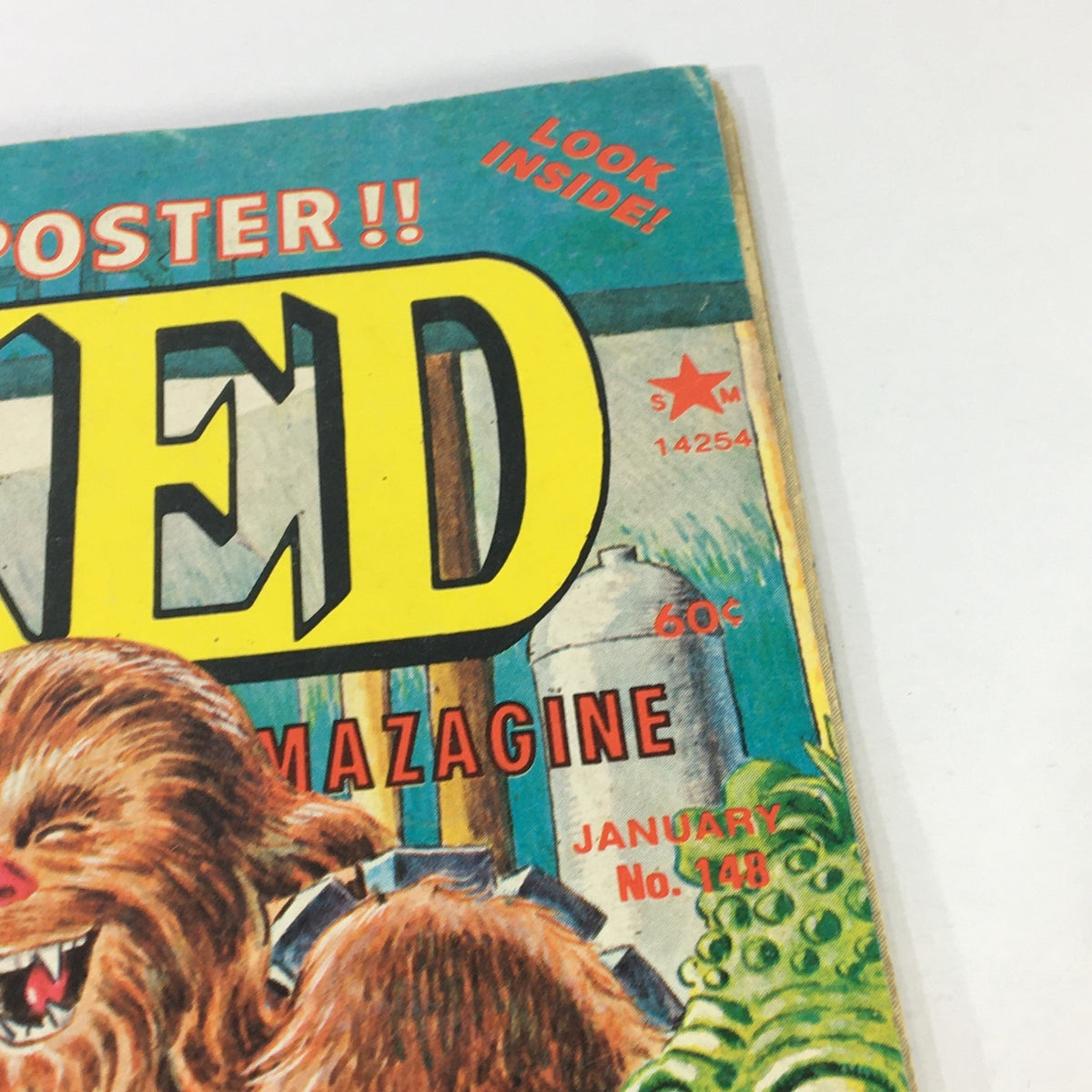 Close-up of the Cracked Magazine January 1978 Issue #148 title with a promotional note for an included poster, highlighting its retro design.