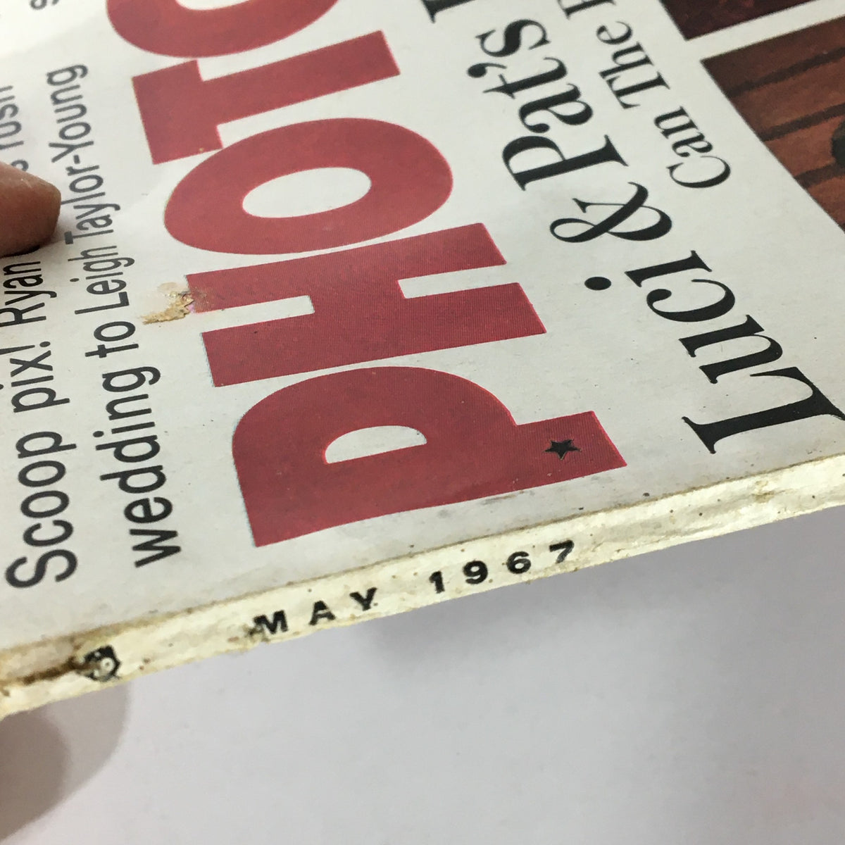 Close-up of the spine of VTG Photoplay Magazine May 1967 showing the date and title, presenting its vintage charm.