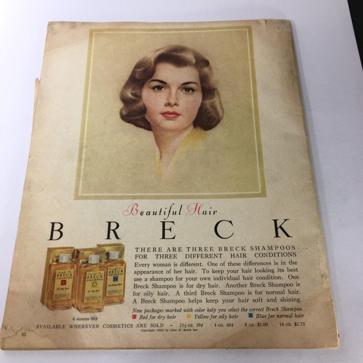 Back cover of VTG Photoplay Magazine January 1961 featuring a vintage advertisement for Breck shampoo, illustrated with a model showcasing beautiful hair.