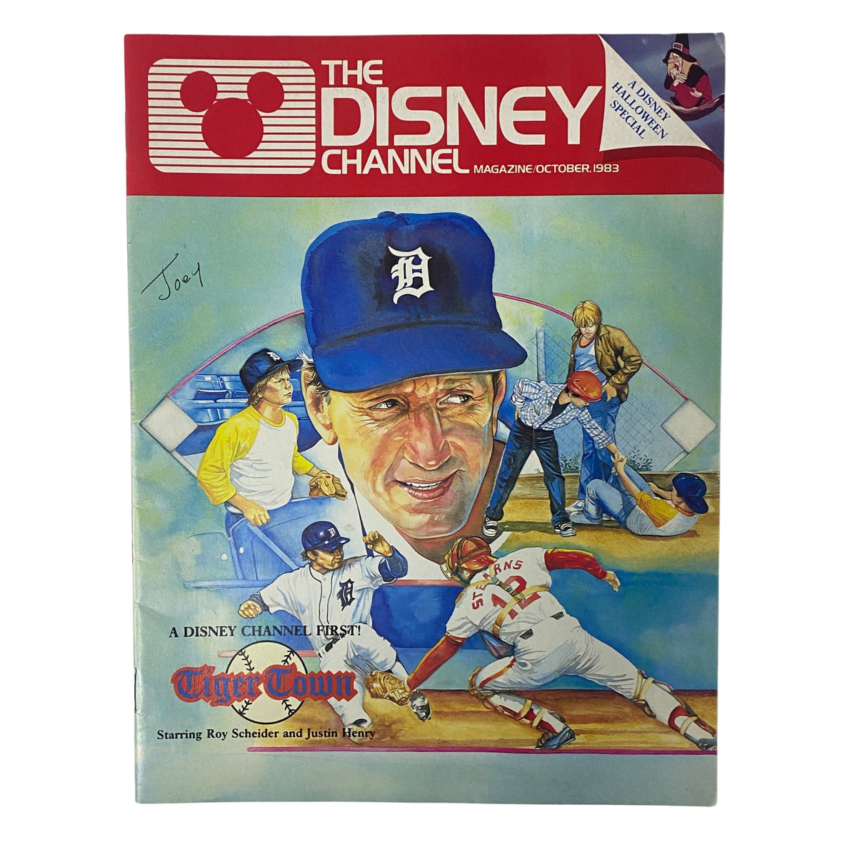 The Disney Channel Magazine October 1983 cover featuring a painting of Roy Scheider and Justin Henry from the Disney Channel Original Movie Tiger Town, showcasing a baseball theme and colorful artwork.