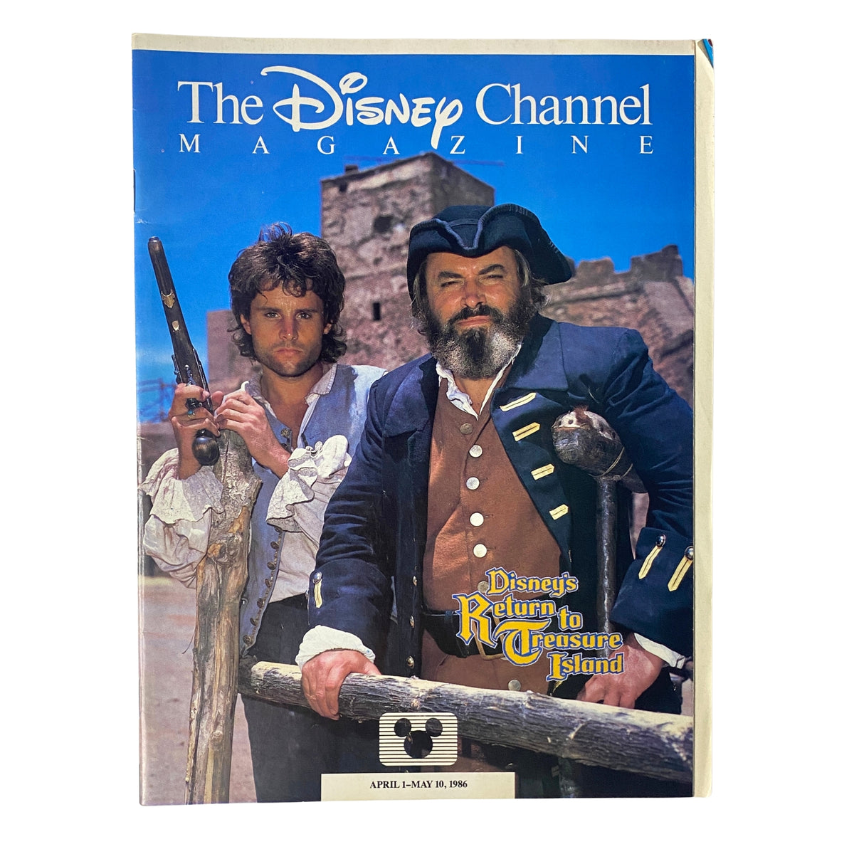 The Disney Channel Magazine April 1-May 10, 1986 cover featuring 'Disney's Return to Treasure Island' with characters in costume, set against a castle backdrop.