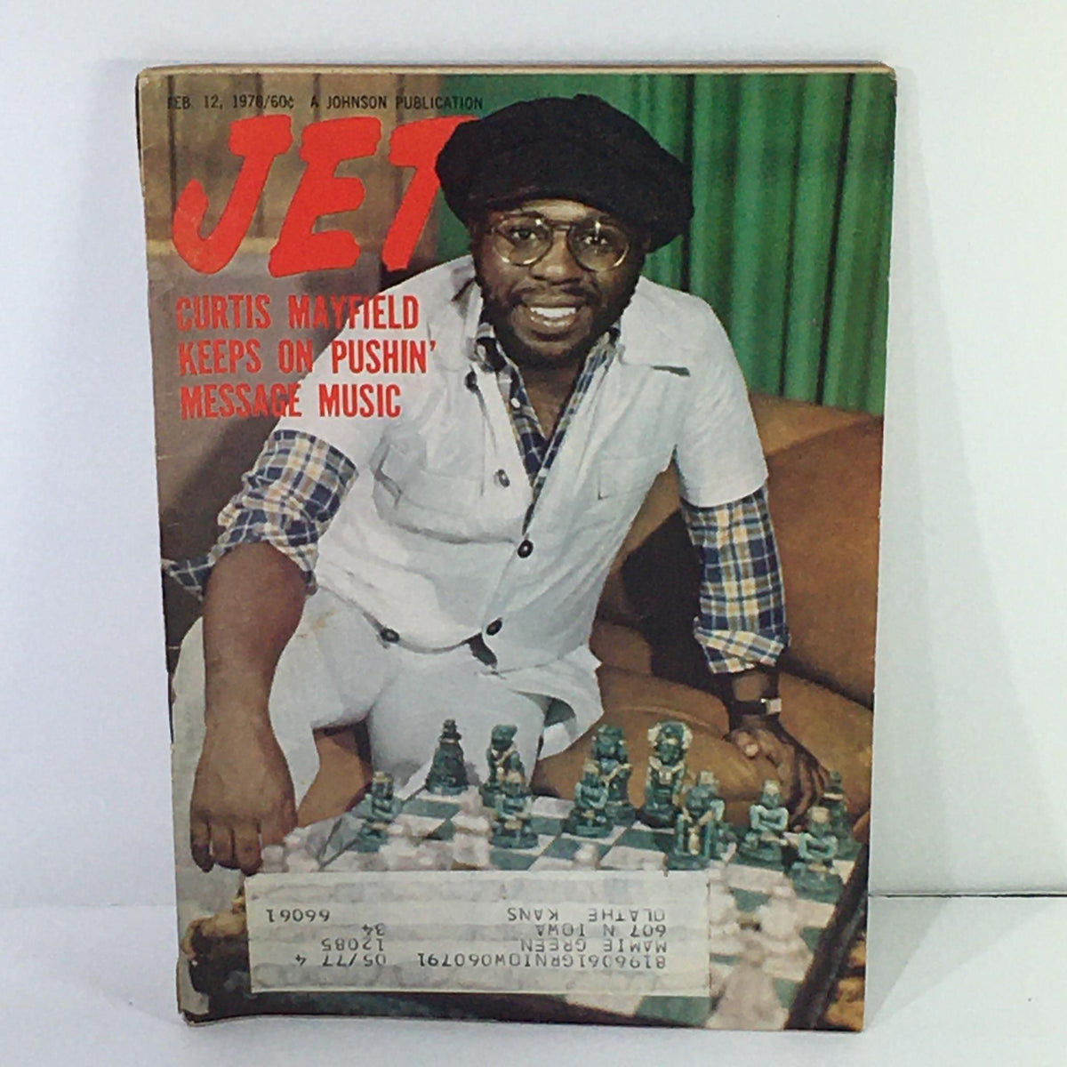 Cover of Jet Magazine dated February 12, 1976, featuring Curtis Mayfield, titled 'Curtis Mayfield Keeps On Pushin' Message Music', showcasing a photo of Curtis Mayfield sitting next to a chessboard.