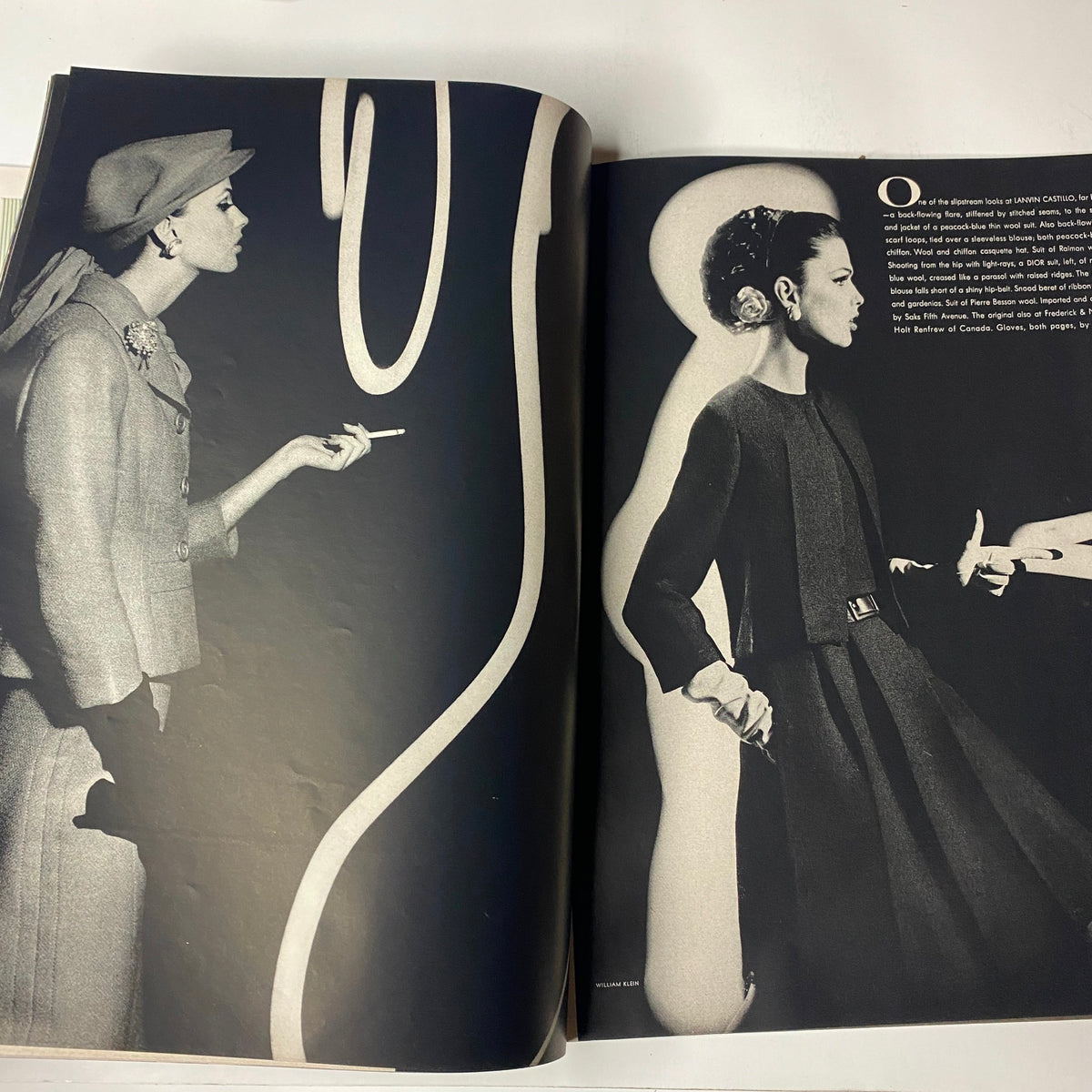 A striking black and white fashion editorial from Vogue Magazine March 15, 1962, highlighting a stylish model adorned with elegant attire against a graphic background.