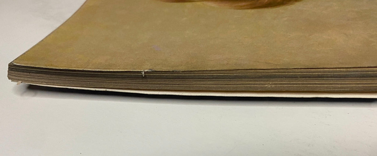 Side view of Vogue Magazine March 15, 1962 highlighting the binding and edge details, featuring Gillis McGil cover by Art Kane.