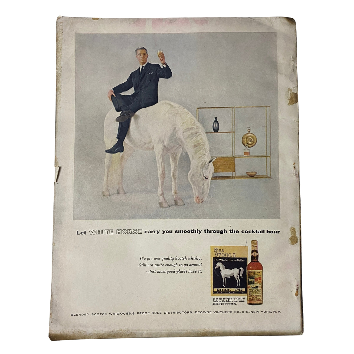 Vogue Magazine November 1, 1955 features a whimsical advertisement for White Horse Scotch Whisky, depicting a dapper man balancing on a horse, illustrating the brand's playful promotion for cocktail hour.