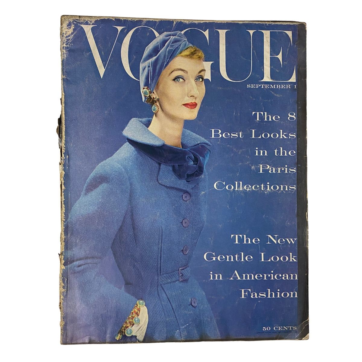 Vogue Magazine September 1, 1954 cover featuring Evelyn Tripp styled in a blue coat with a matching hat, showcasing the elegance of mid-1950s fashion, photographed by Erwin Blumenfeld.