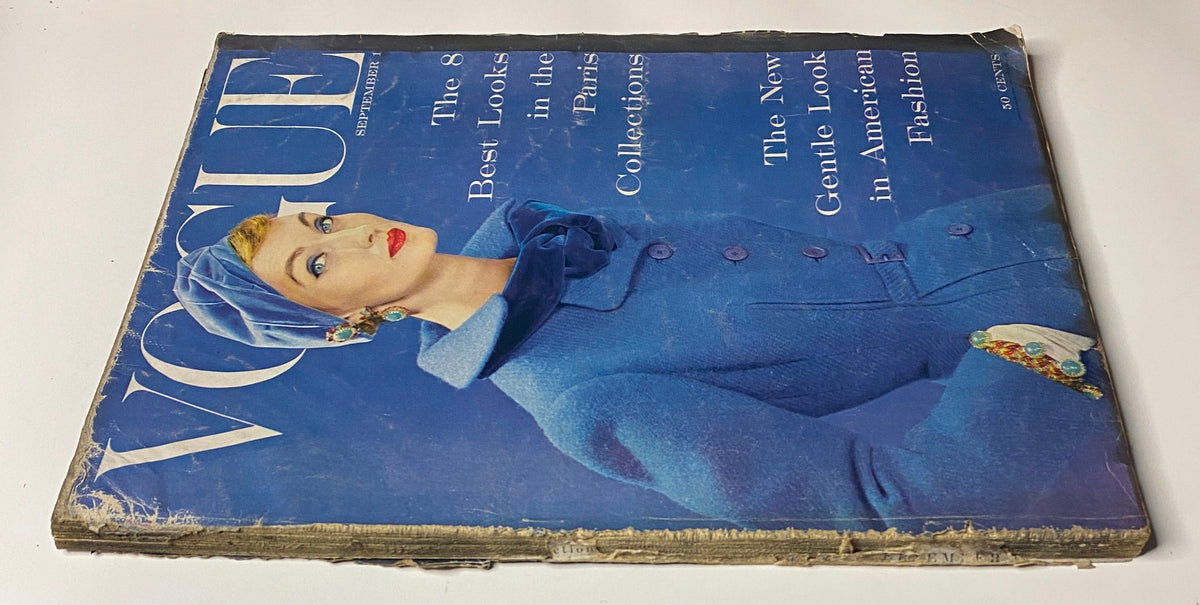 Vogue Magazine September 1, 1954 cover, depicting Evelyn Tripp in a chic blue outfit, highlighting the latest Parisian fashions and American influences, captured by Erwin Blumenfeld.