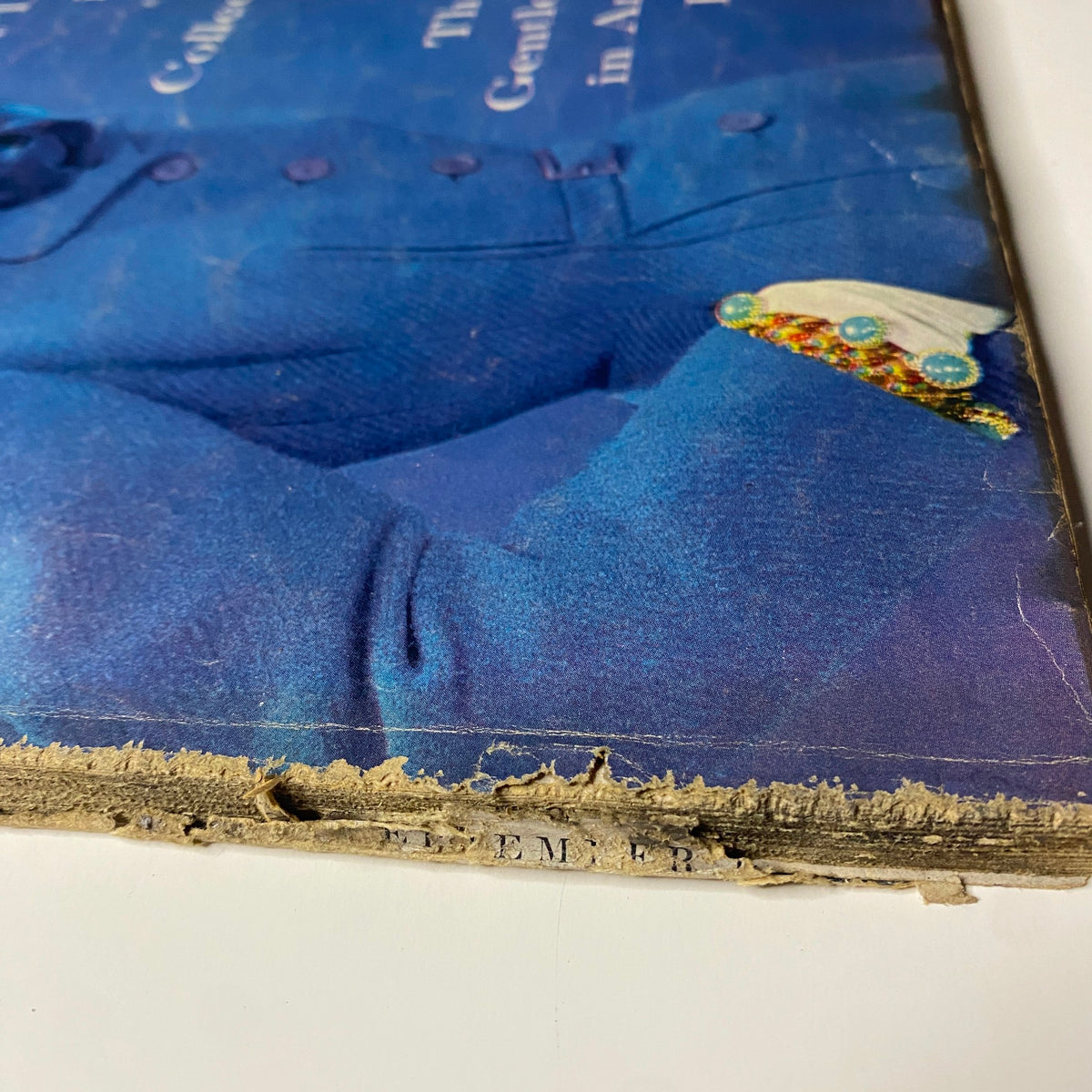 Close-up of the spine and corner wear of Vogue Magazine September 1, 1954, highlighting its vintage characteristics and history.