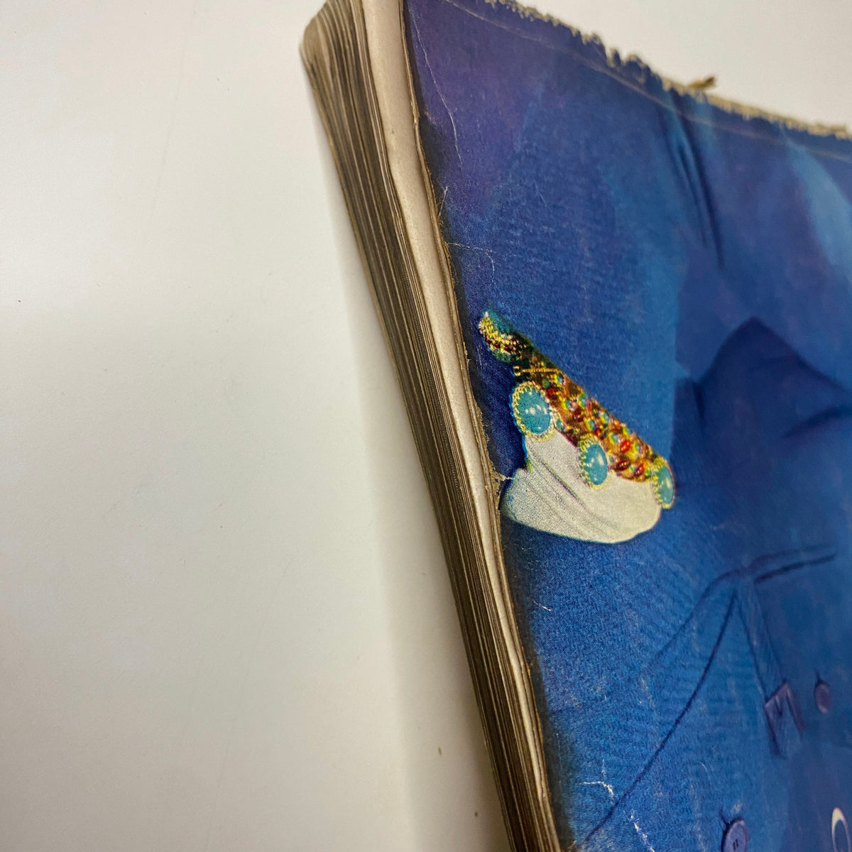 Vogue Magazine September 1, 1954 Evelyn Tripp by Erwin Blumenfeld captures the wear and age of the magazine with a close-up of the spine featuring frayed edges and visible wear.