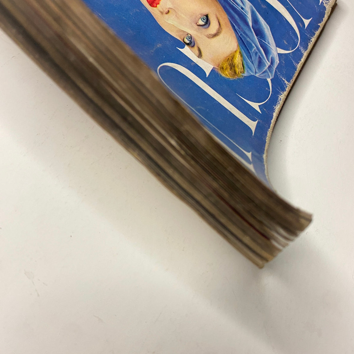 Vogue Magazine September 1, 1954 Evelyn Tripp by Erwin Blumenfeld displays the worn outer edge of the magazine, showcasing its vintage character and condition.