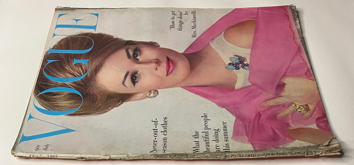 Close-up view of Vogue Magazine July 1962, highlighting Anne De Zogheb's cover image, styled with a bold pink scarf and captivating jewelry, a vintage representation of 1960s fashion.