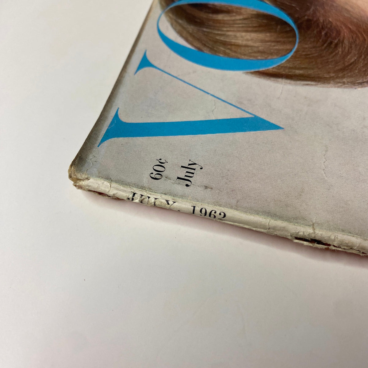 Side view of Vogue Magazine July 1962, displaying the month and year 'JULY 1962', capturing the magazine's vintage charm and historical significance in fashion history.