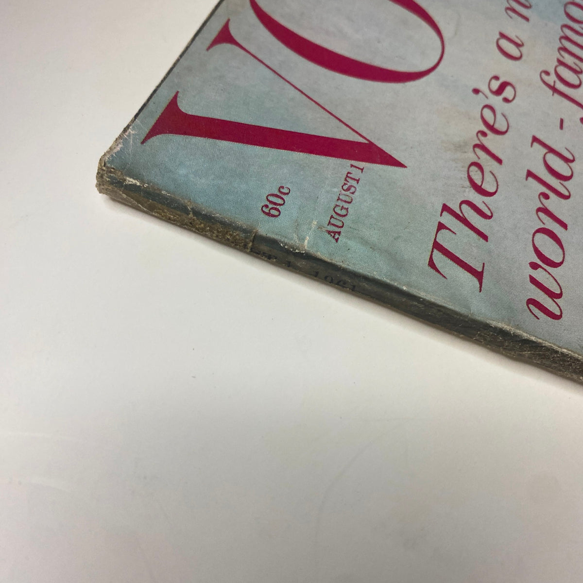 Side view of Vogue Magazine August 1, 1961 showing the spine and vintage wear, indicative of age and preservation.