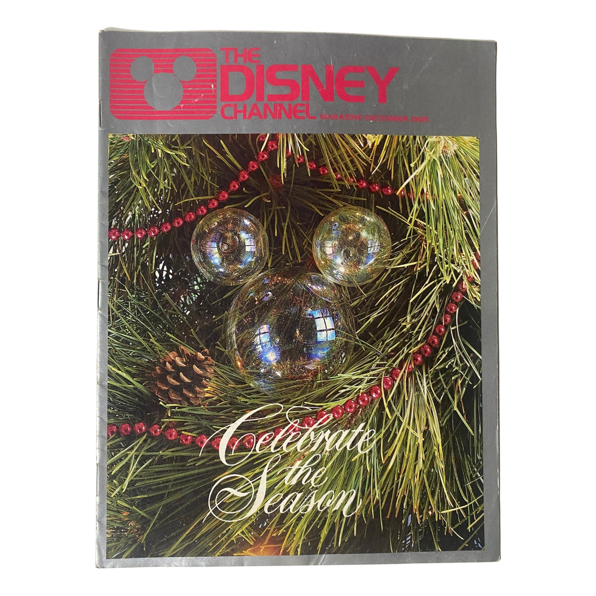Cover of The Disney Channel Magazine December 1985 featuring a festive design with Christmas ornaments and the text 'Celebrate the Season'