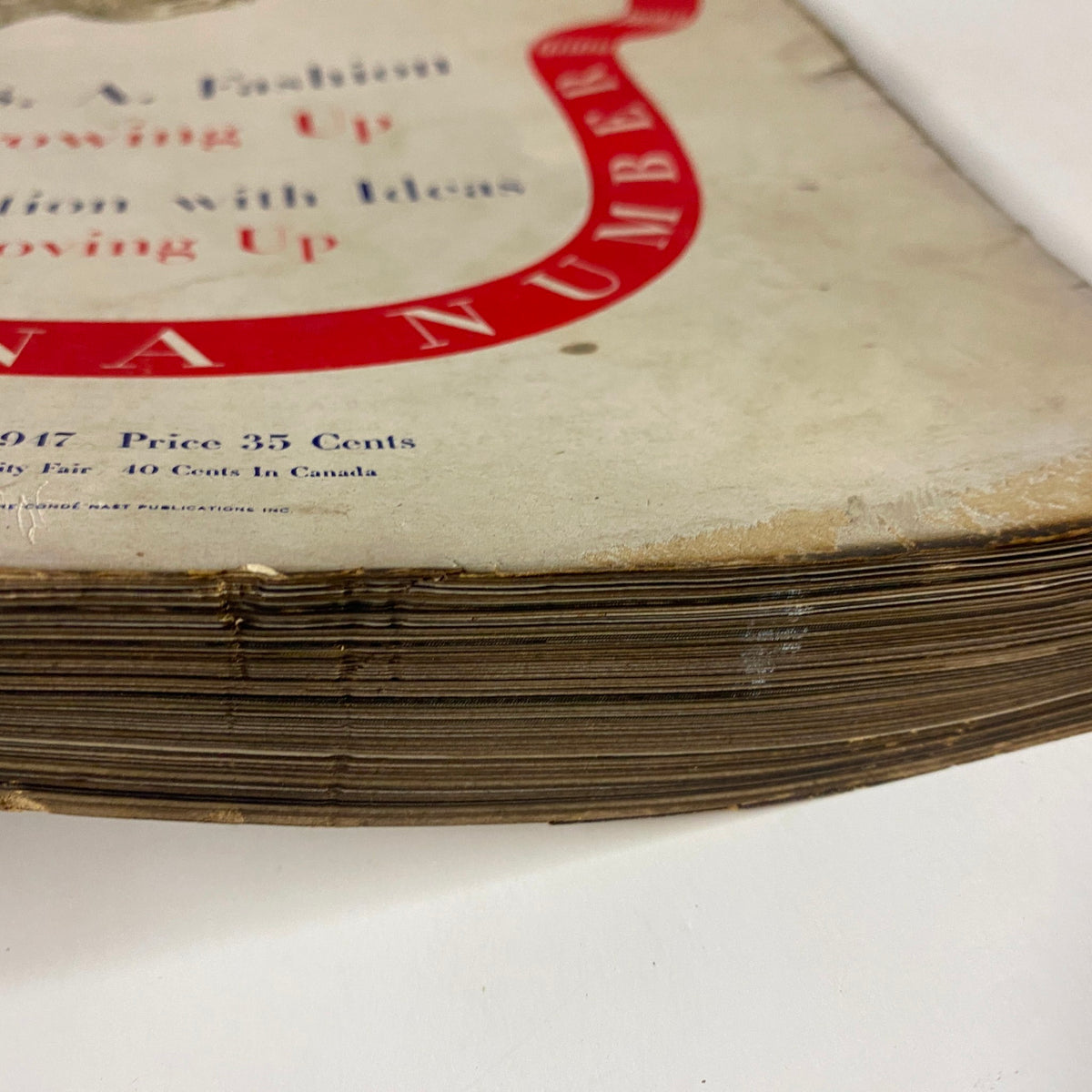 Detailed view of the worn edges of the Vogue Magazine February 1, 1947, highlighting its vintage authenticity and age.