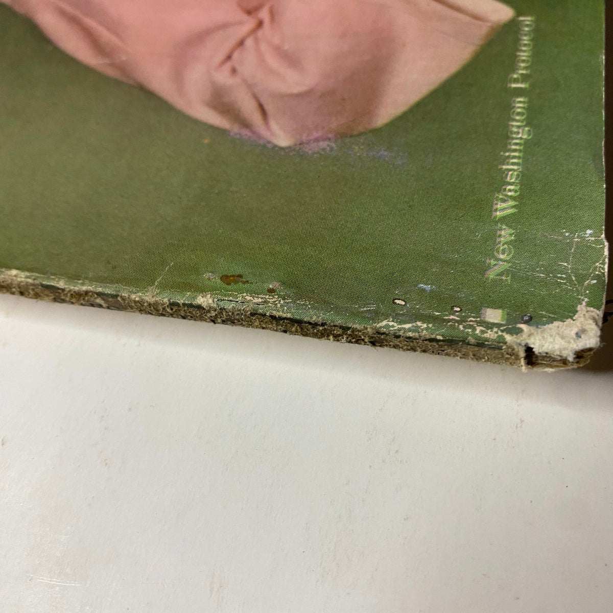 Detail of the spine of Vogue Magazine June 1961 with visible wear, highlighting the magazine's vintage appeal featuring cover photo of Dorothy McGowan by Tom Palumbo.