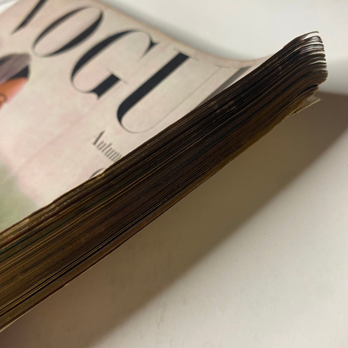 Vogue Magazine September 1, 1944 Selene Mahri Cover by John Rawlings. Close-up of the spine of the vintage magazine, emphasizing its wear and nostalgic appeal from the mid-20th century.