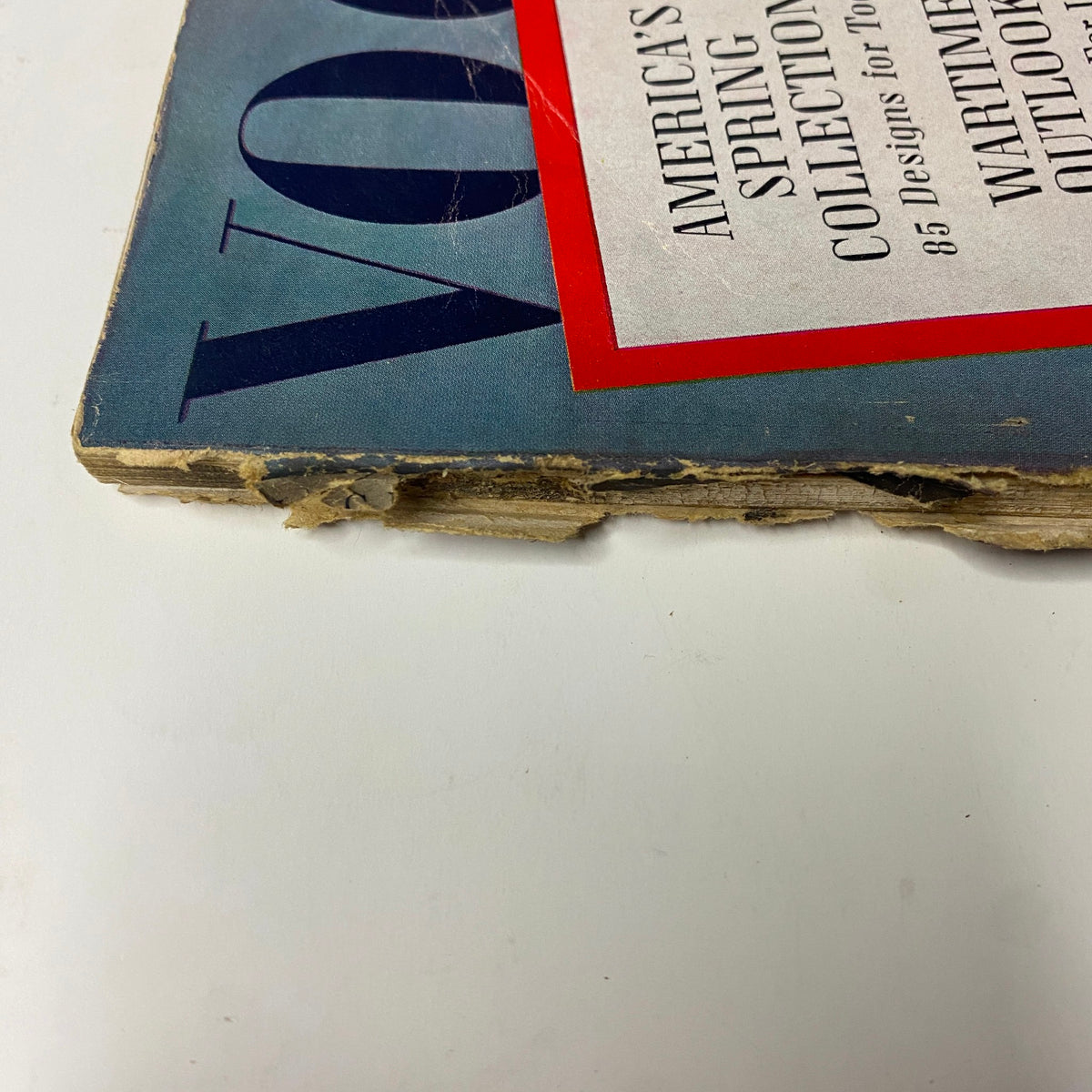 Side photo of Vogue Magazine March 1, 1942 Wartime Look cover by Horst P. Horst highlighting the magazine's spine and wear over time.