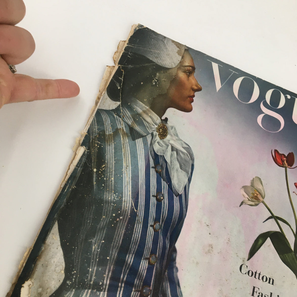 Close-up of the Vintage Vogue Magazine May 1 1944 cover highlighting the wear and details of the model's stylish striped cotton outfit.
