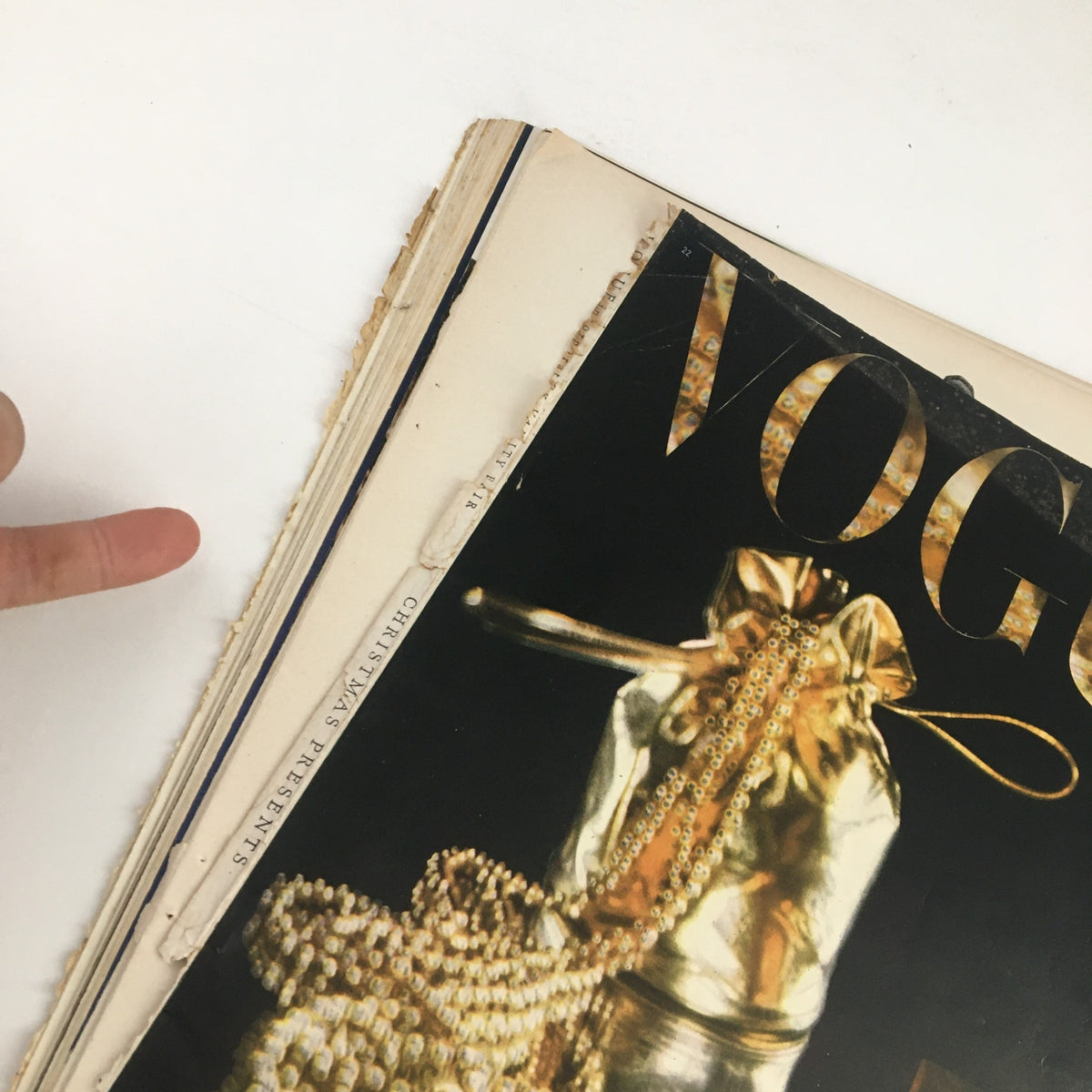 Close-up view of the cover of the VTG Vogue Gifts Magazine November 15, 1945 featuring a luxurious gold gift bag, emphasizing the vintage theme of holiday presents.