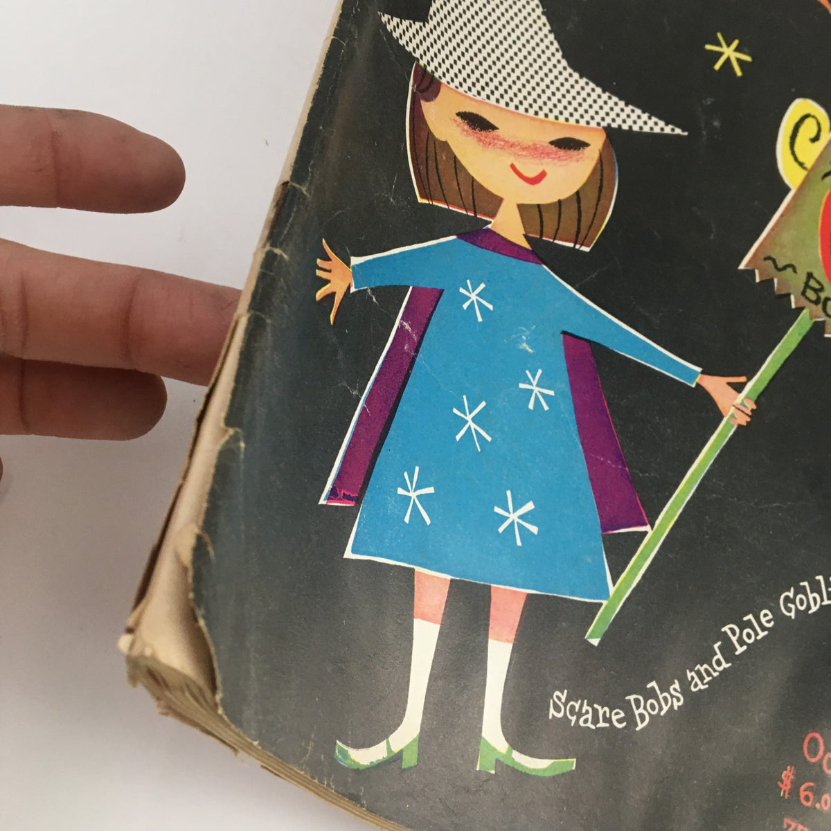 Close-up of the cover of VTG The Instructor Magazine October 1958, highlighting the illustration of a girl in a blue dress with a witch hat holding a Halloween-themed mask.