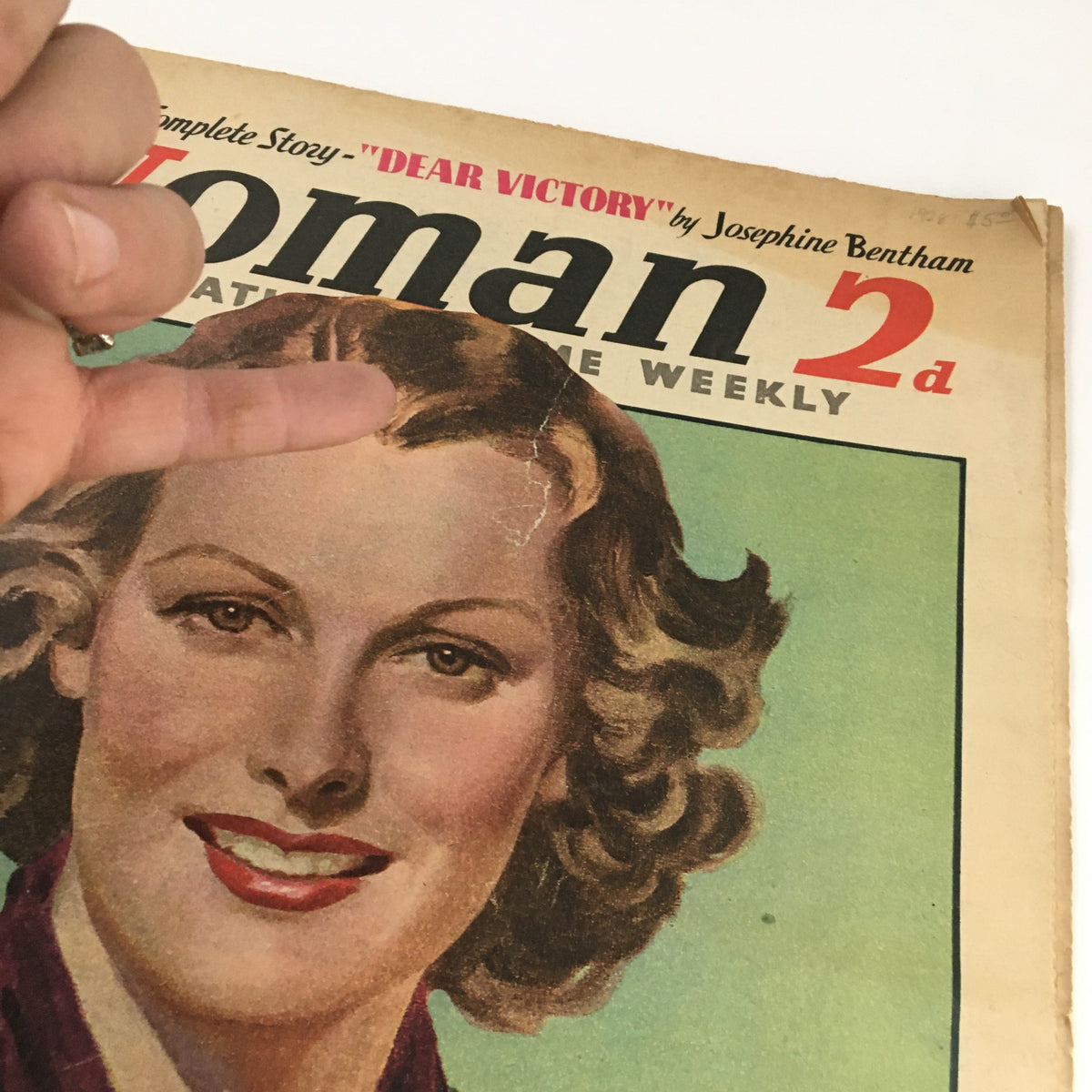 Close-up of The National Home Weekly Magazine cover from June 18, 1938, highlighting the detailed illustration of a woman’s face and minor imperfections, part of the promotion for 'Dear Victory' by Josephine Bentham.