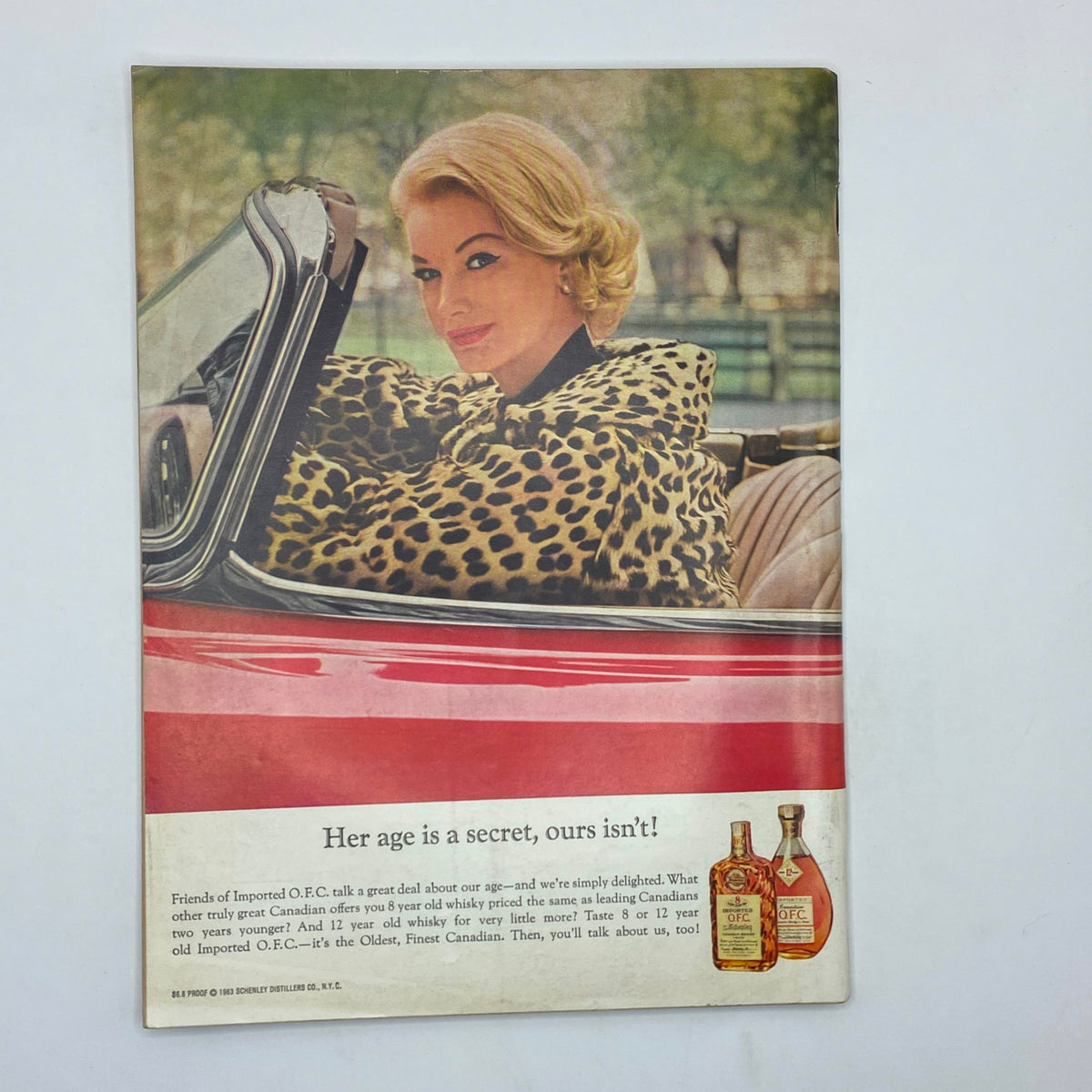 Vintage advertisement from The New Yorker Complete Magazine April 13, 1963 Charles E. Martin Cover, showing a woman in a leopard print coat in a convertible with text discussing whisky.
