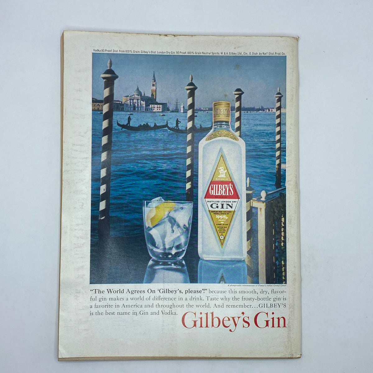Vintage advertisement for Gilbey's Gin featured in The New Yorker Complete Magazine April 4, 1964, showcasing a bottle against a scenic backdrop of Venice.