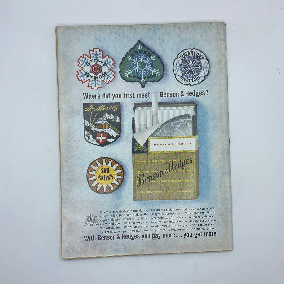 Back cover of The New Yorker, March 21, 1964 issue, showcasing an advertisement for Benson & Hedges cigarettes, with imagery including badges of ski resorts and a pack of cigarettes.