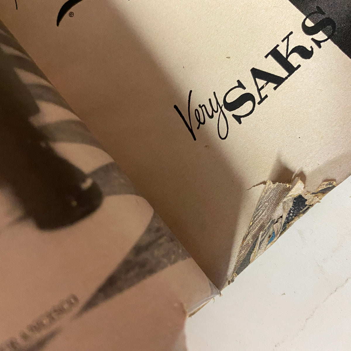 Detail of the damaged interior page of Vogue Magazine March 1, 1959 featuring Isabella Albonico, with visible corner wear and markings, representing the magazine's history.
