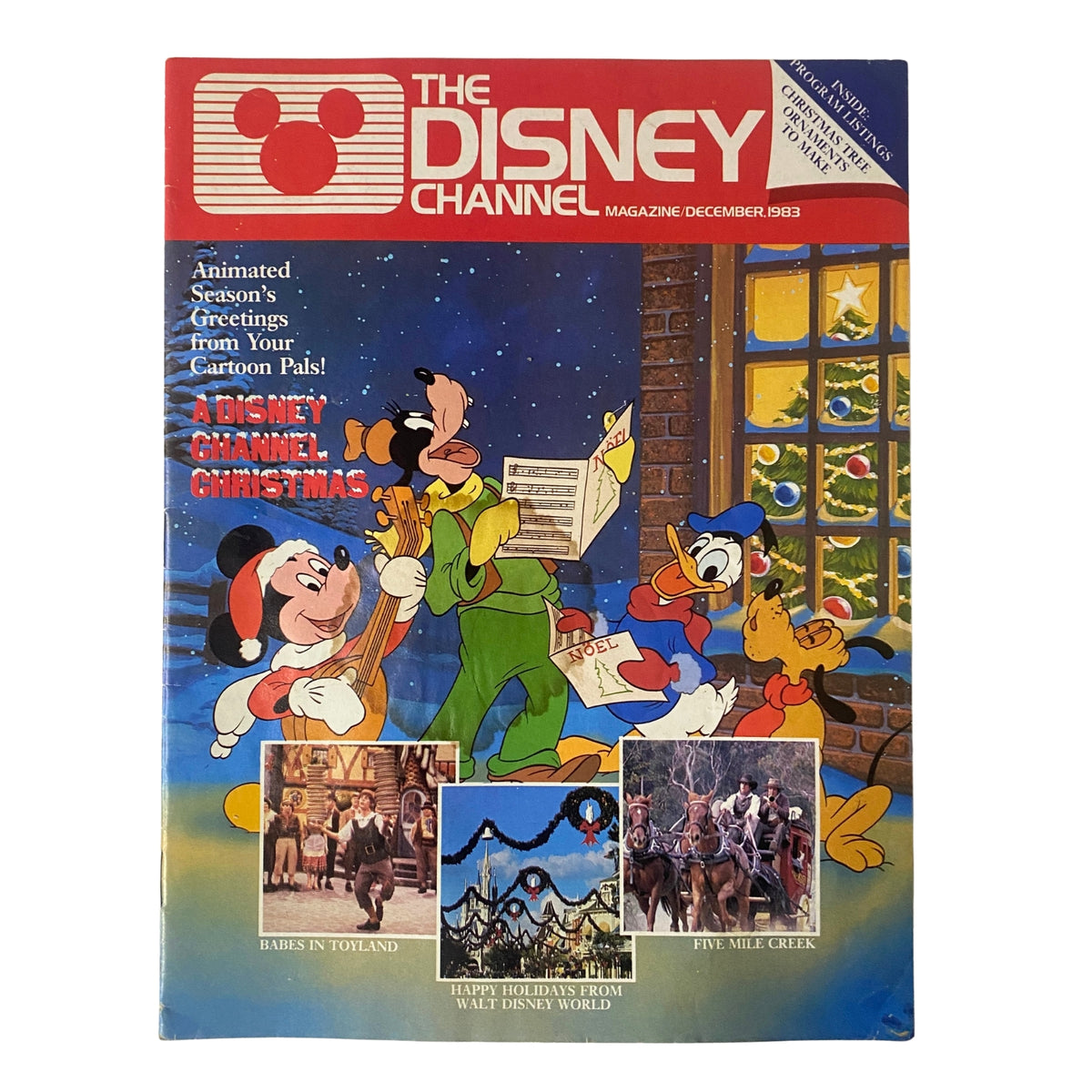 The Disney Channel Magazine December 1983 featuring Mickey Mouse and friends celebrating Christmas with bright illustrations and festive decorations.