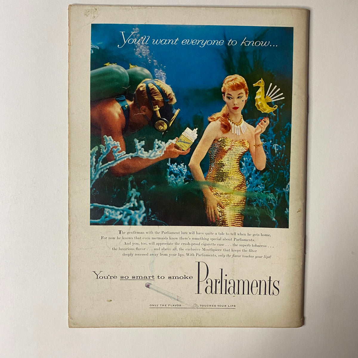 Back cover of Gourmet Magazine May 1956 featuring a vintage ad for Parliaments cigarettes, depicting a woman in a golden dress swimming with an underwater diver.